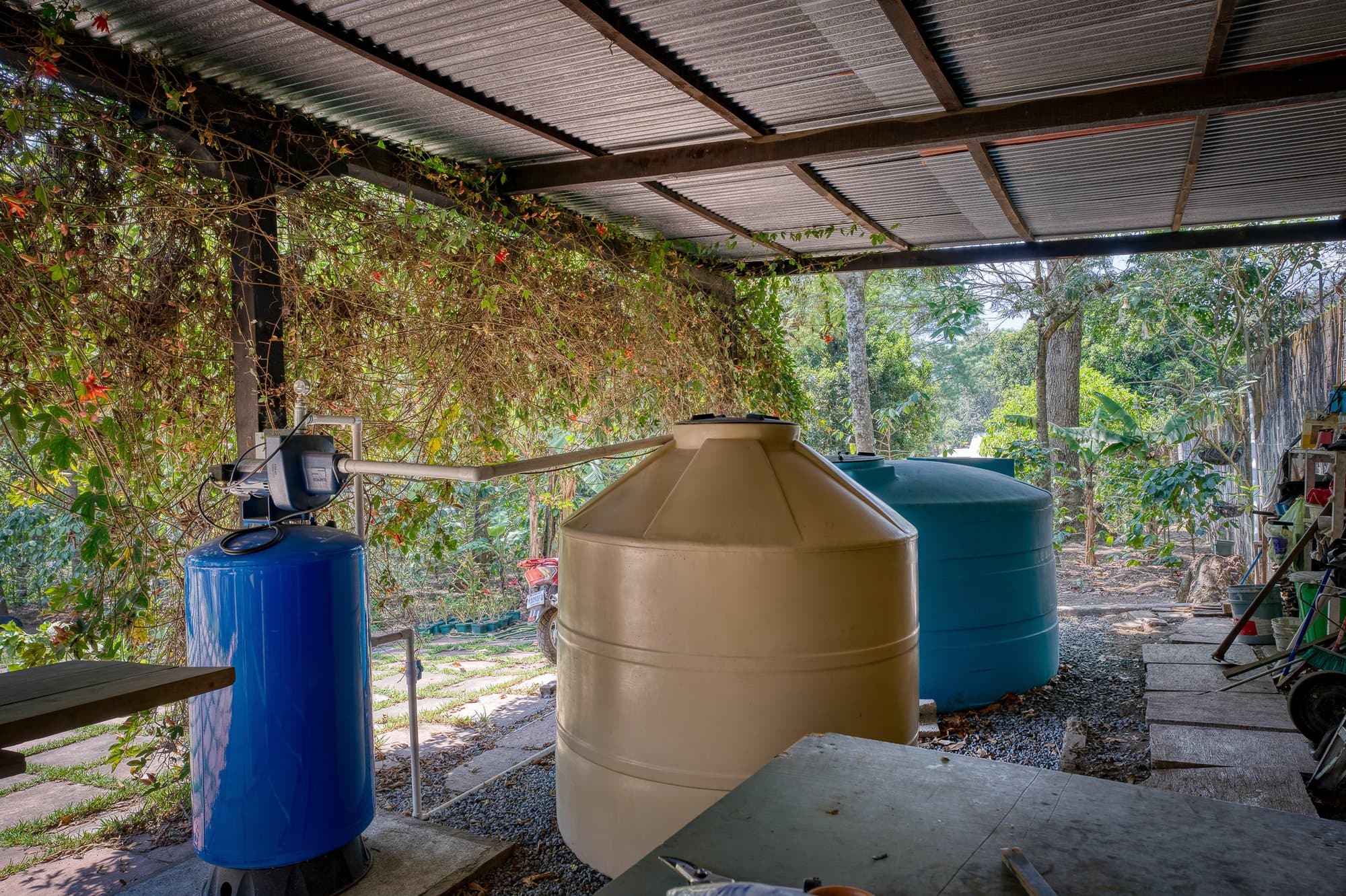 Covered water storage with pressure tank and pump